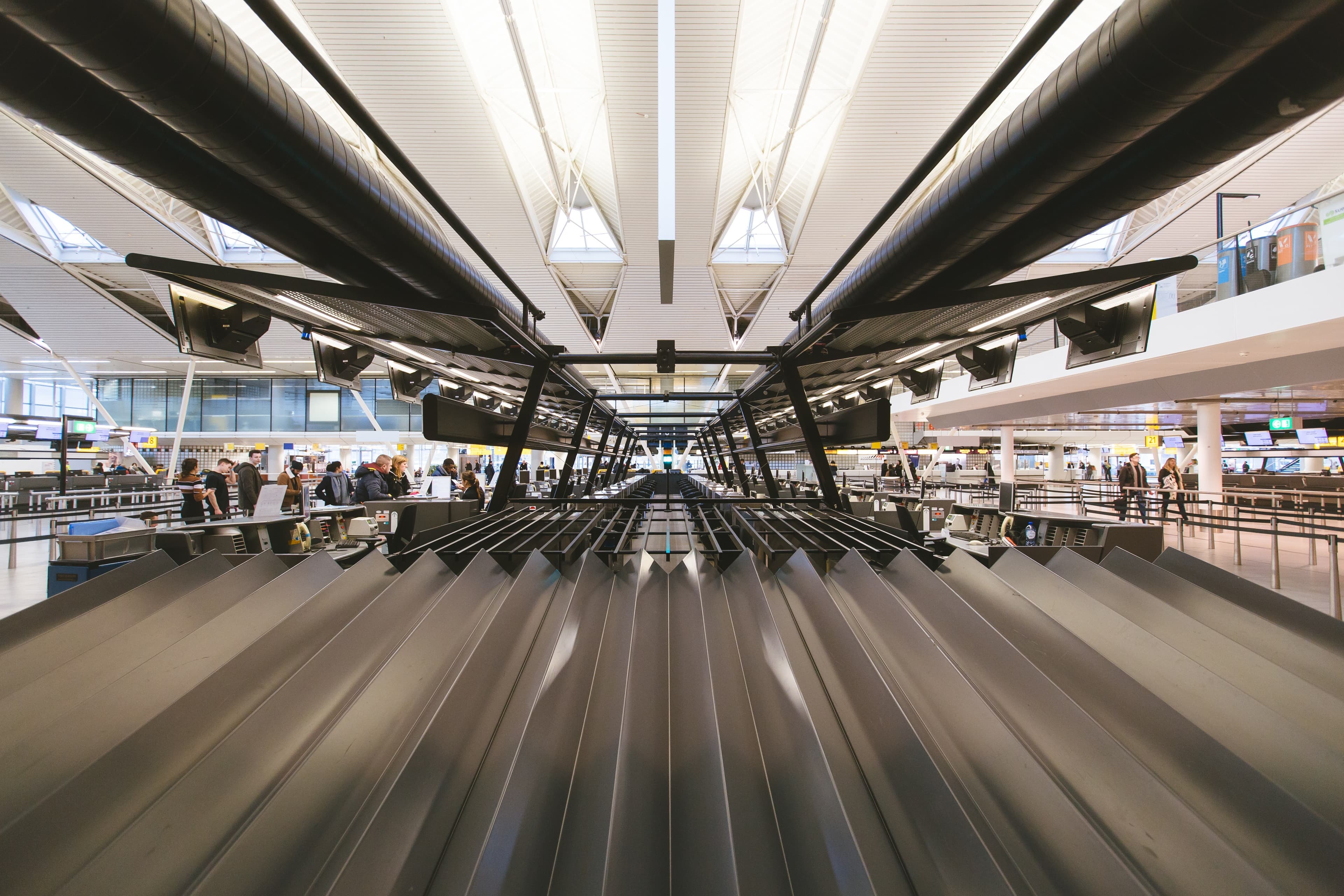 Airport check-in hall with baggage conveyors and passengers